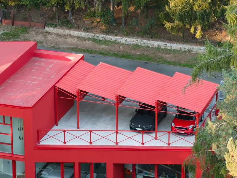 Aerial view of the corrugated metal carport sheltering two vehicles on the upper terrace
