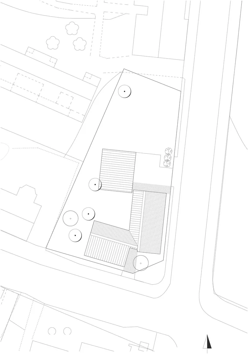 Site plan drawing showing three rectangular roofed volumes arranged around circular tree symbols