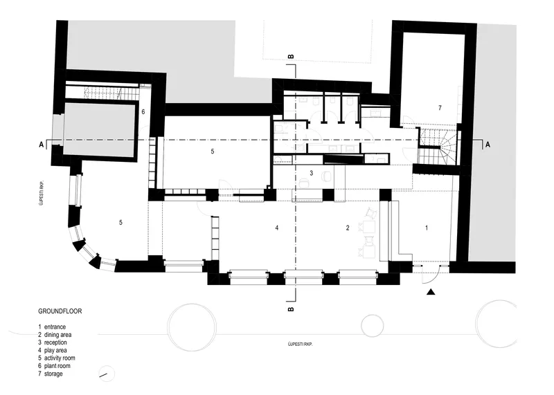 Ground floor plan drawing showing entrance and activity spaces around thick masonry walls