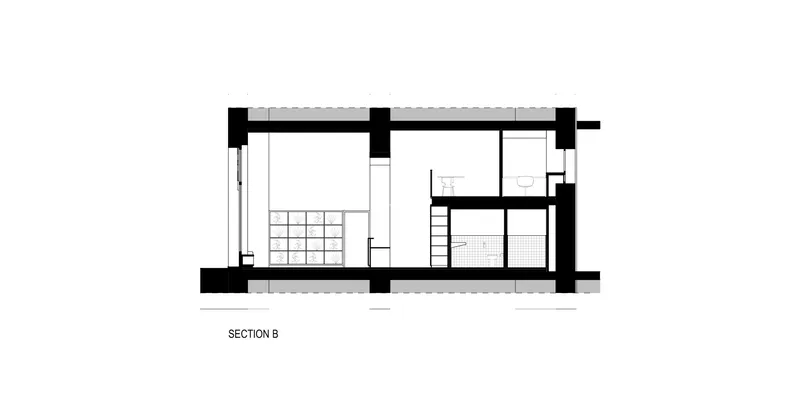 Section drawing depicting a double-height space with gridded window and interior partitions
