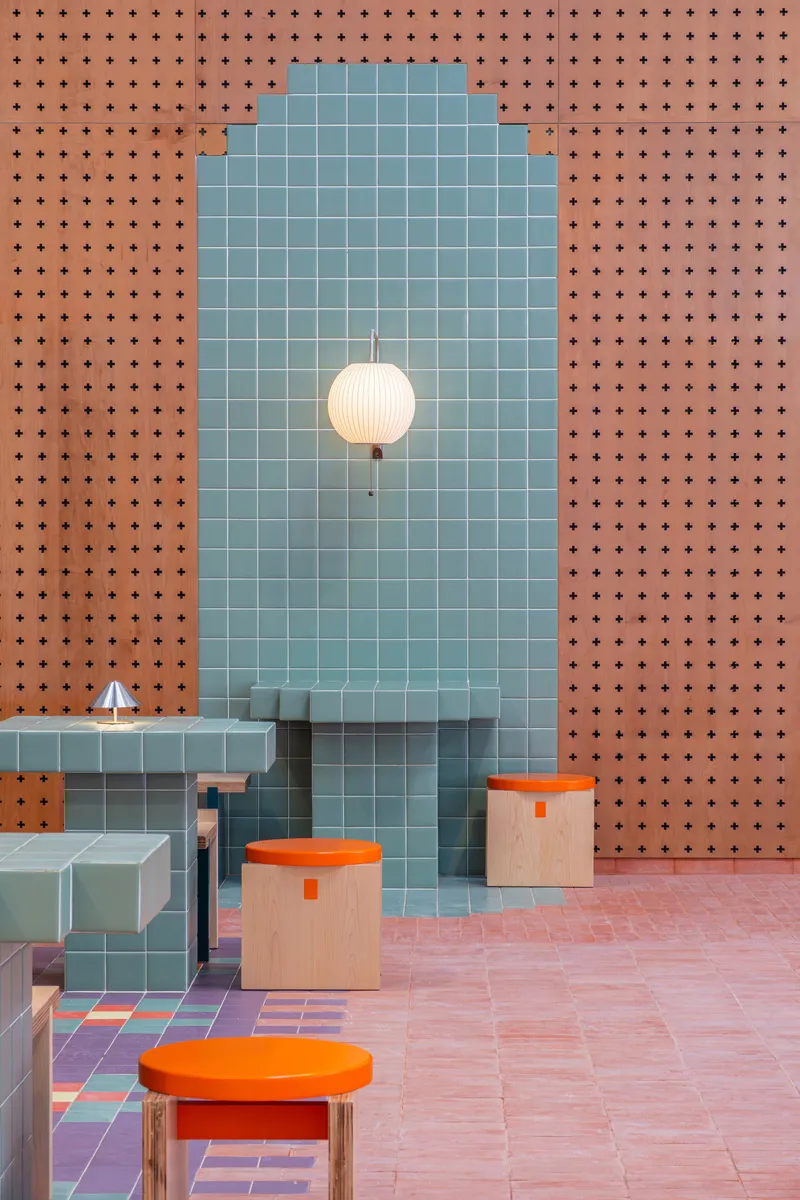 Single arched niche with blue tile, spherical pendant light and perforated terracotta wall surround
