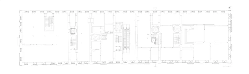 Floor plan drawing depicting an elongated space with staircases and symmetrical side chambers