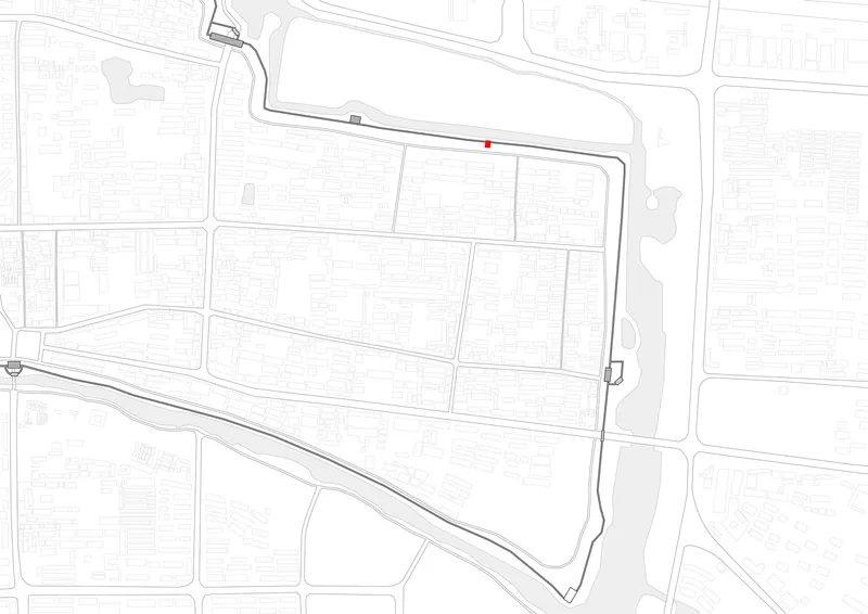 Site plan drawing showing the building location marked in red within the surrounding urban block and canal edge