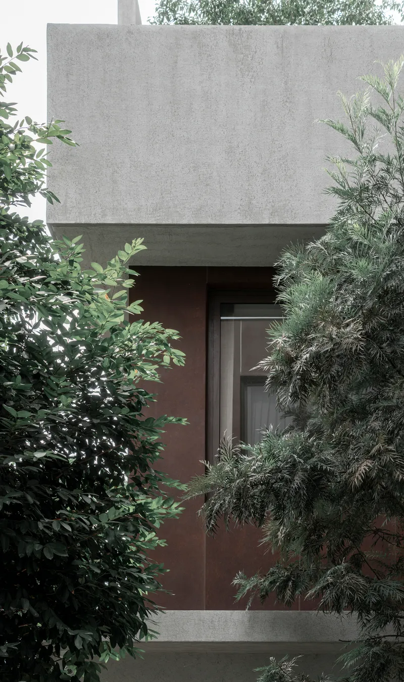 Recessed concrete entrance framed by trees with a dark timber door beneath an overhanging upper volume