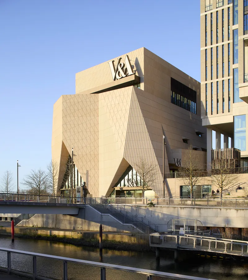 Waterfront elevation showing the patterned tile facade and angled corner forms above the canal walkway