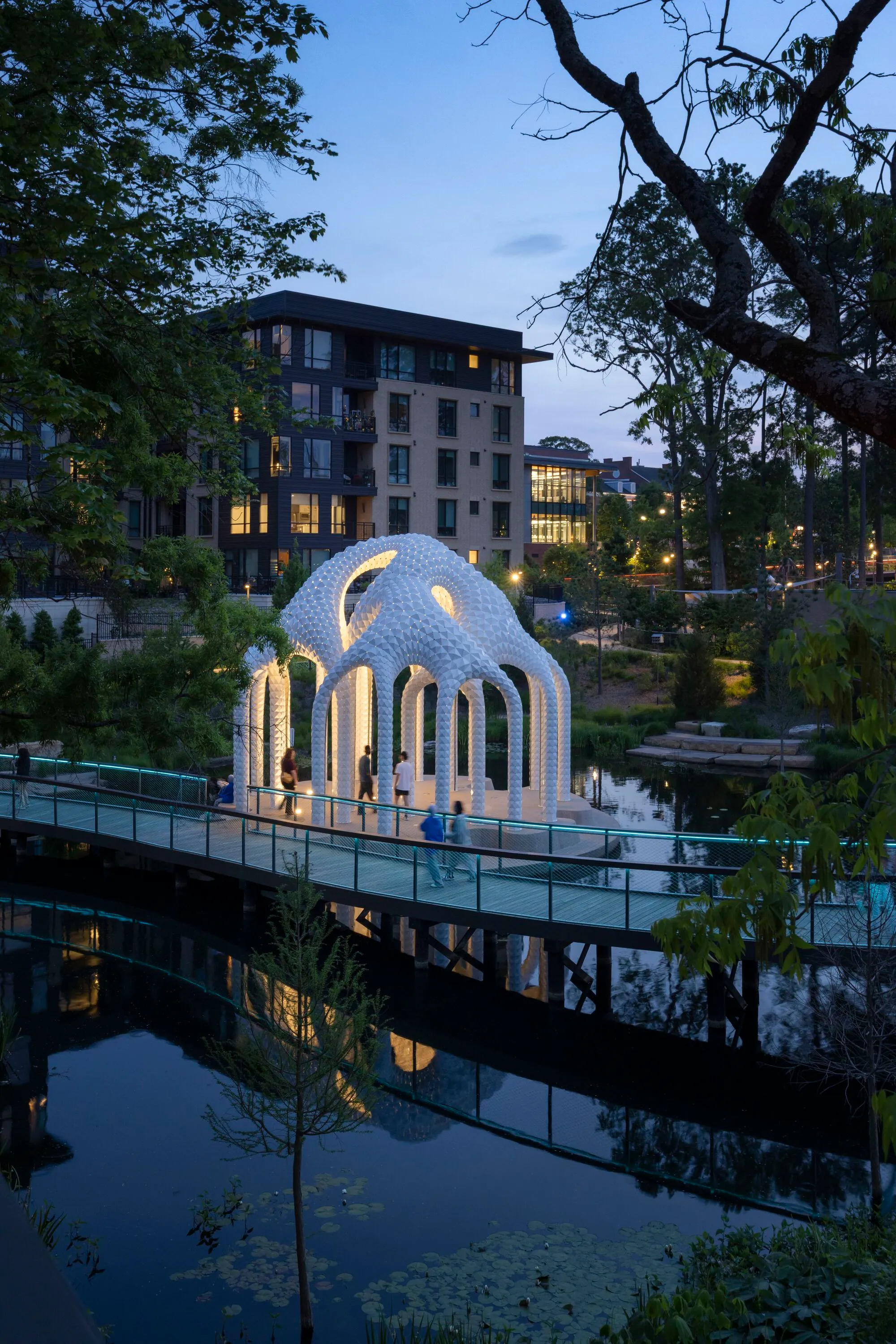Marc Fornes Floats a Perforated Aluminum Folly on a Pond in Downtown Cary