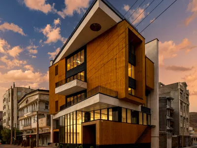 White Cube Atelier Wraps a Rotating Mixed-Use Volume in Timber on a Tight Corner in Maku