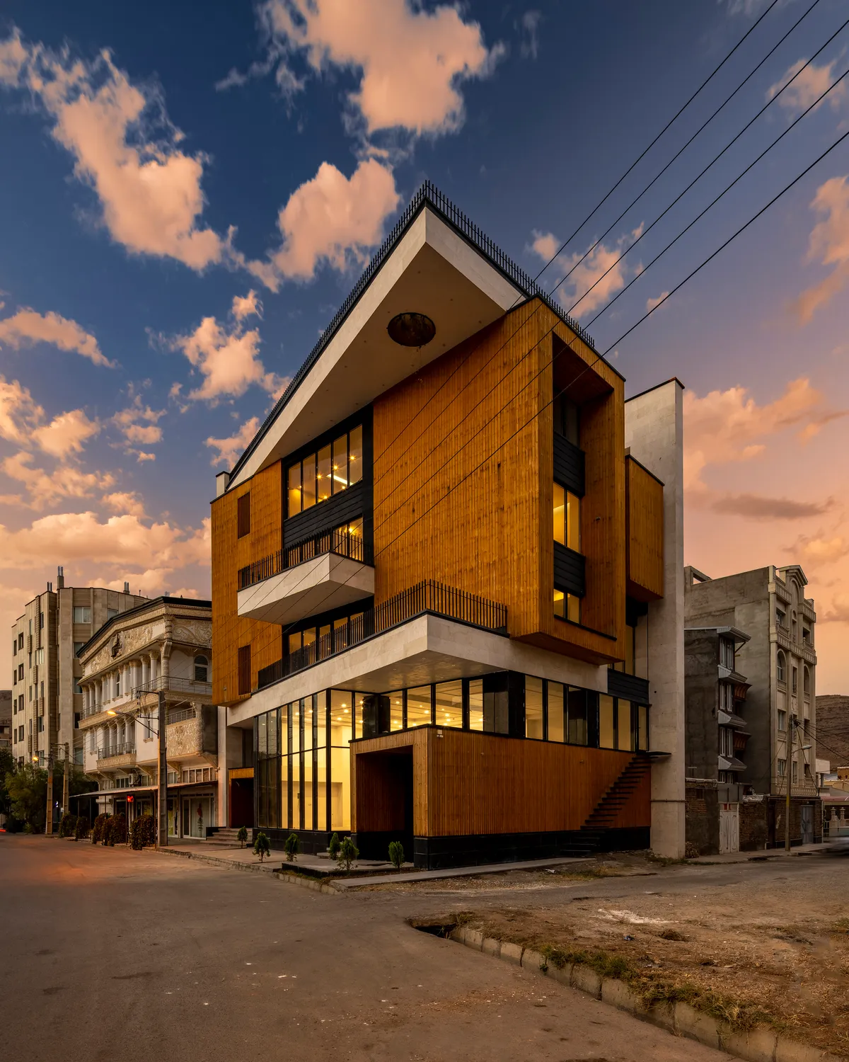 White Cube Atelier Wraps a Rotating Mixed-Use Volume in Timber on a Tight Corner in Maku