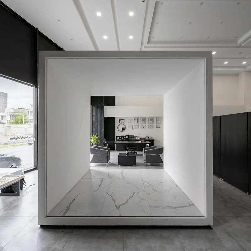 White framed volume with marble flooring viewed through a freestanding threshold in the showroom