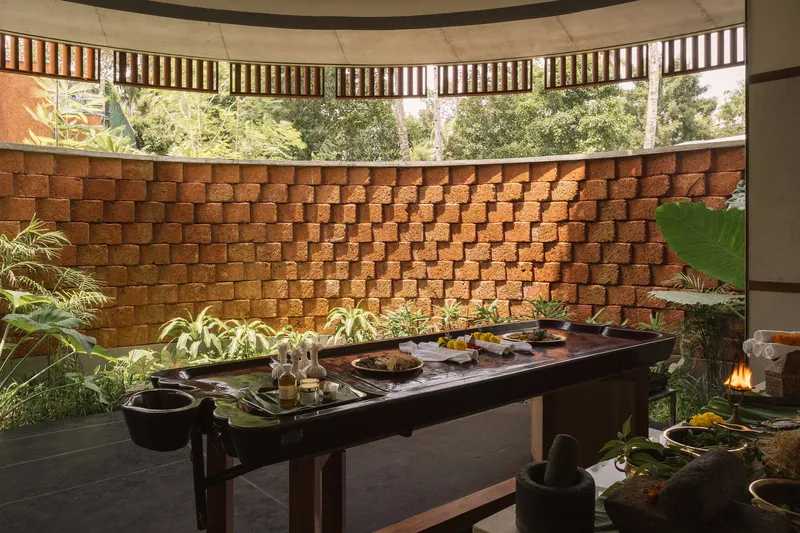 Curved stacked brick wall behind a preparation counter in a semi-enclosed dining pavilion