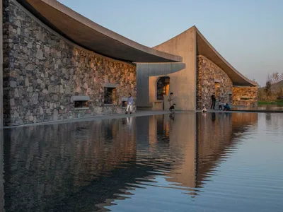 Studio Zhu-Pei Drapes Concrete Tent Roofs Over a Stone Courtyard Art Center in Zibo