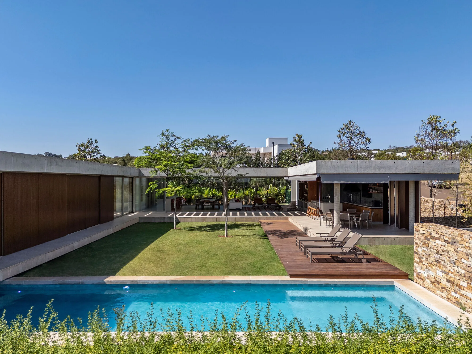 Swing House Folds Timber and Concrete Into a Hillside