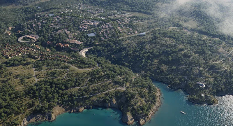 Aerial view of a residential development nestled in forested hillsides along a rocky coastline