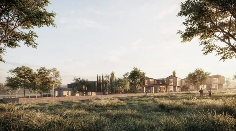 Site rendering showing low-rise buildings scattered across a grassy meadow with deciduous trees