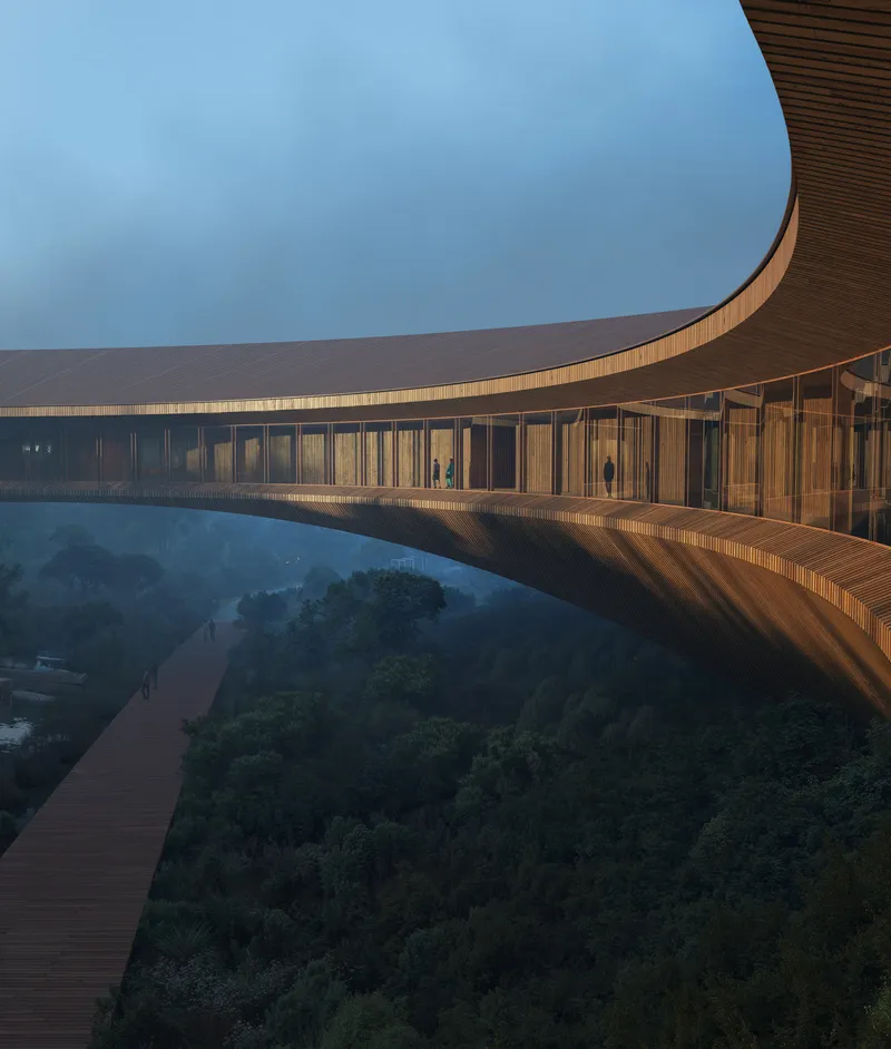 Elevated timber walkway with curved glass facade and ribbed wooden soffit in warm evening light
