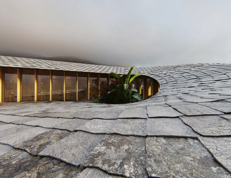 Undulating stone shingle roof with planted courtyard opening and glazed timber-framed rooms visible beneath foggy sky