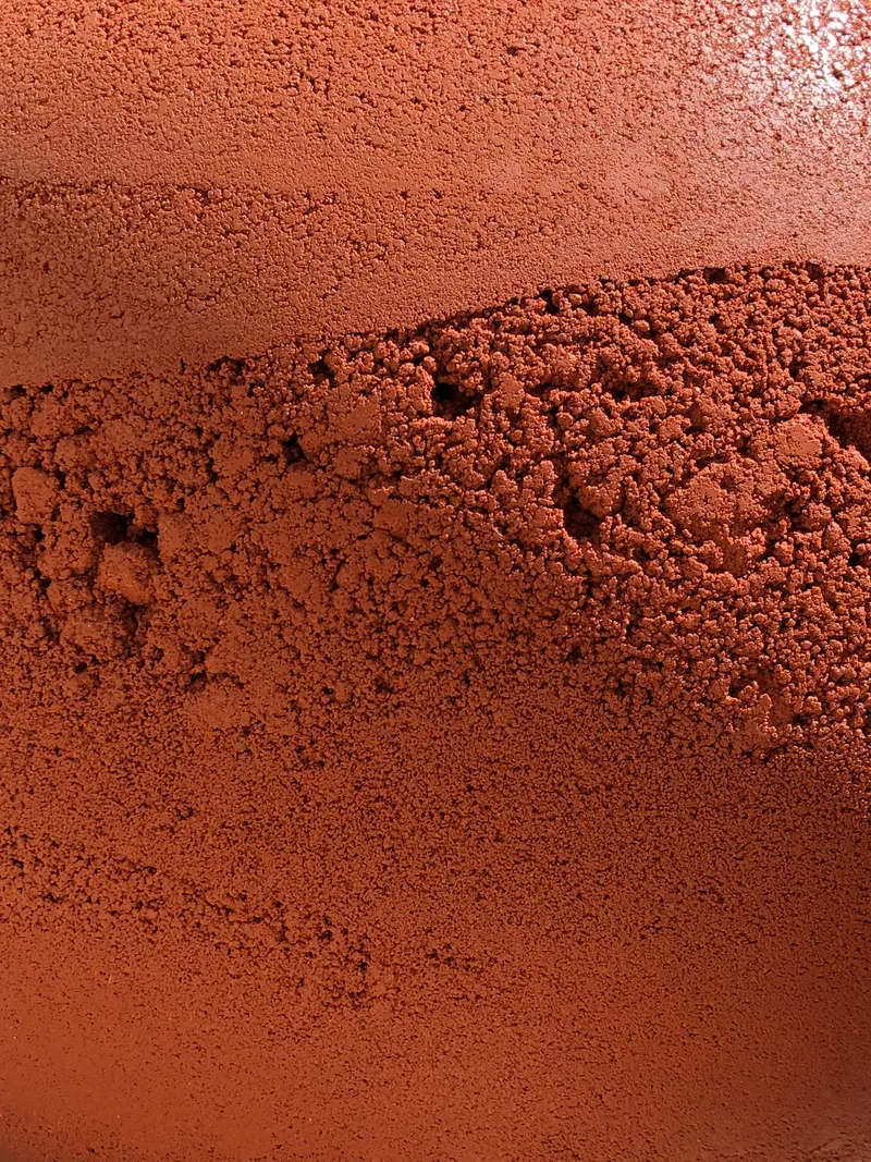 Detail of textured terracotta surface with visible tooling marks and aggregate