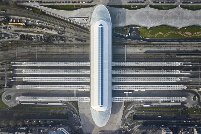 Overhead view of the elongated terminal with parallel platform canopies and central glazed volume
