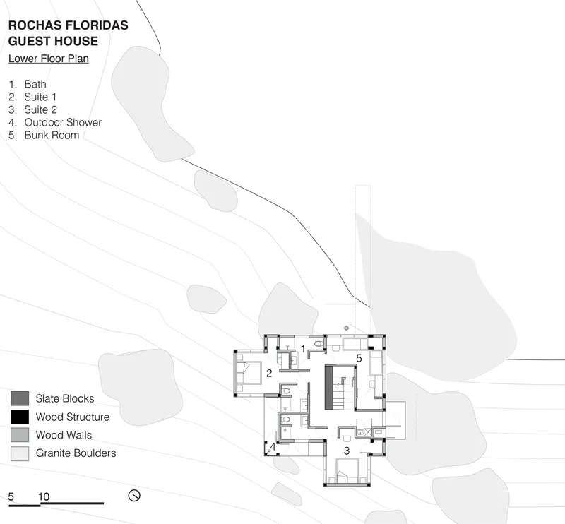 Lower floor plan showing bedroom suites and bunk room nestled among topographic contours and granite boulders