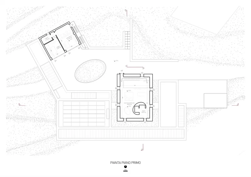 First floor plan drawing showing interior spaces with a spiral staircase and surrounding landscape