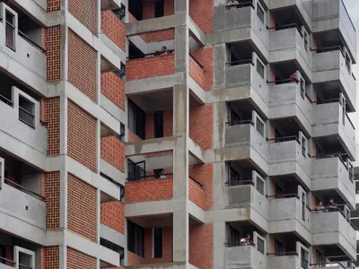 Studio Frozen Music Replaces a Generic Nashik Tower with a Stepped Brick and Concrete Housing Block