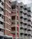 Studio Frozen Music Replaces a Generic Nashik Tower with a Stepped Brick and Concrete Housing Block