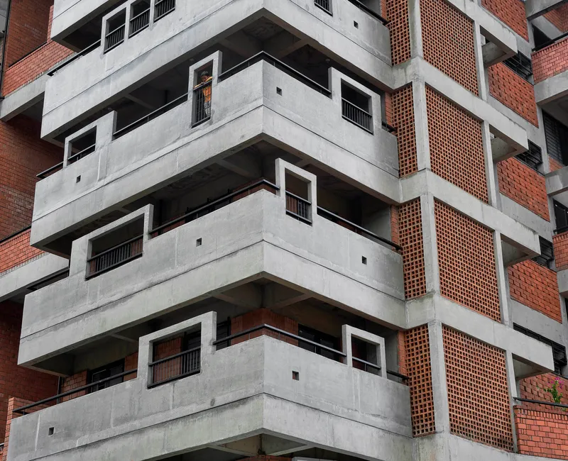 Corner detail of the concrete floor slabs with perforated brick screens set between structural columns