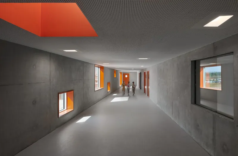 Concrete hallway with orange window reveals and figures walking through shafts of sunlight