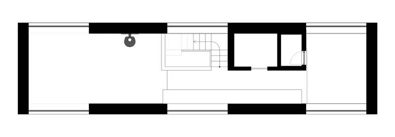 Floor plan drawing showing open layout with central staircase and wood-burning stove
