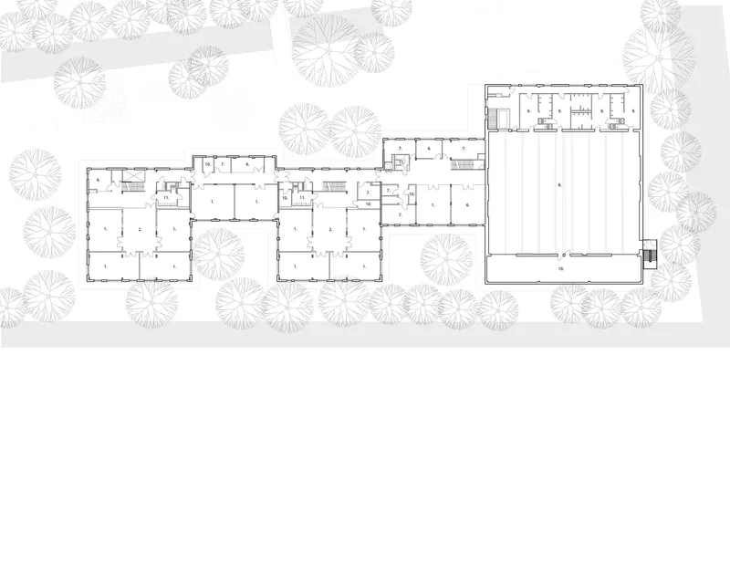 Floor plan drawing showing interconnected classroom wings with gymnasium and courtyard spaces