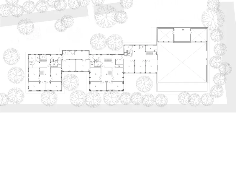 Site plan drawing showing three connected building volumes surrounded by circular tree symbols