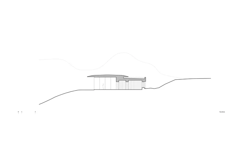 Section drawing showing the building profile nestled into the hillside terrain