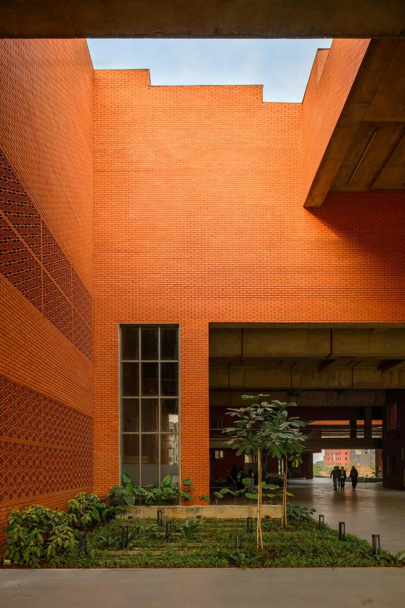 Internal courtyard with stepped brick walls, planted beds and a concrete ceiling soffit