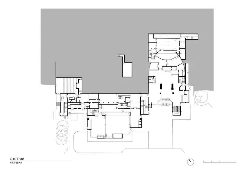 Ground floor plan drawing showing interconnected rooms with central circulation and theater space
