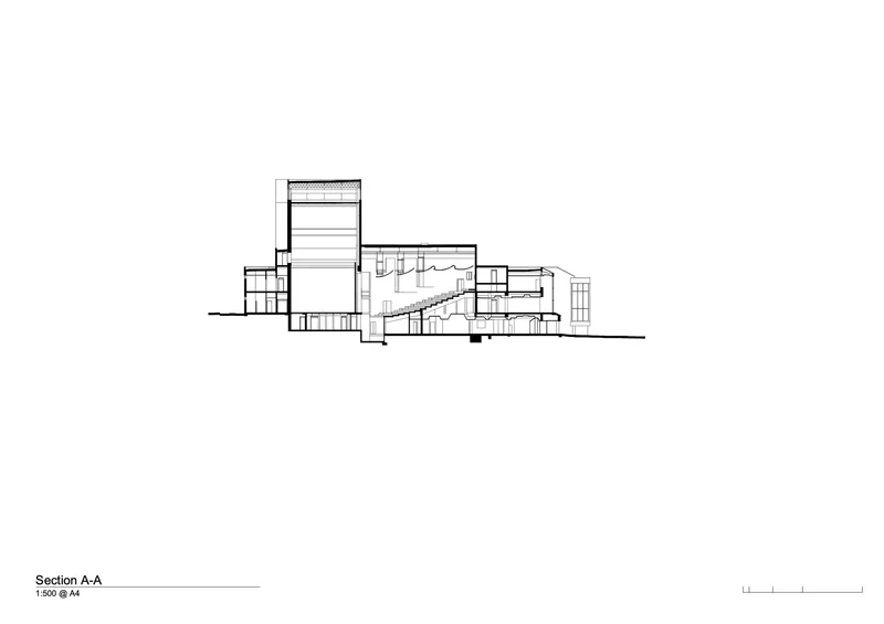 Section drawing showing a tall volume with a diagonal staircase connecting multiple floor levels