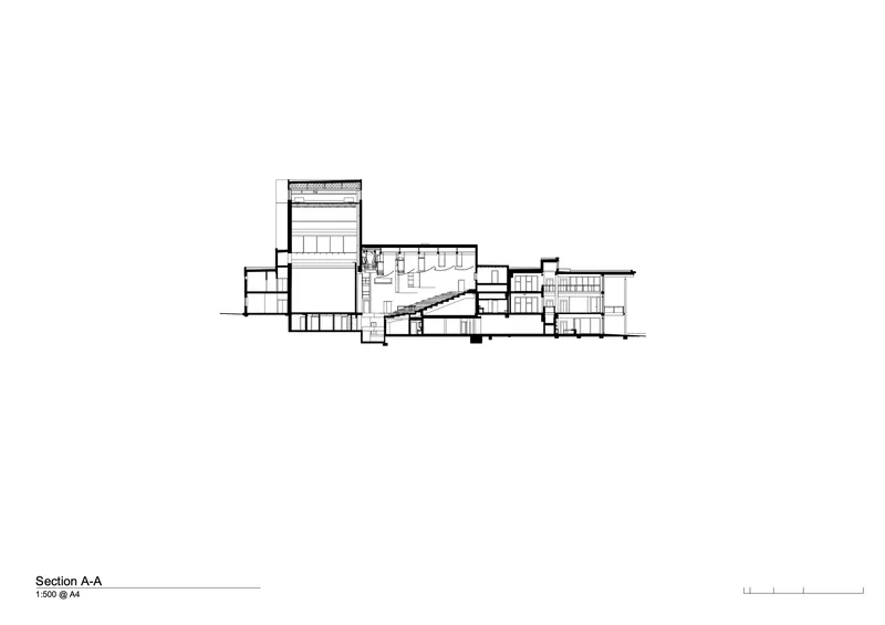 Section drawing revealing interior spaces with a central staircase and varied ceiling heights