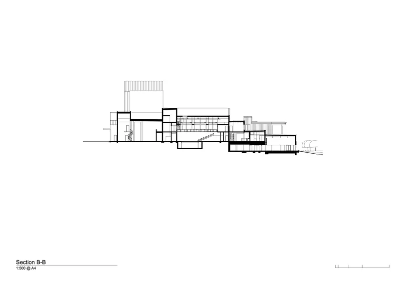 Section drawing displaying interconnected volumes with terraced levels and roof planes