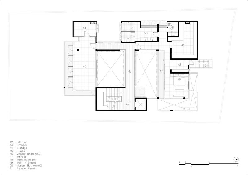 Floor plan drawing showing bedrooms and service spaces arranged around two double-height voids