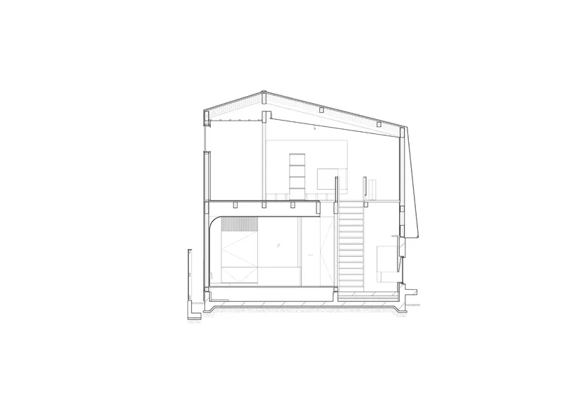 Section drawing revealing a two-story interior with pitched roof, staircase, and built-in storage