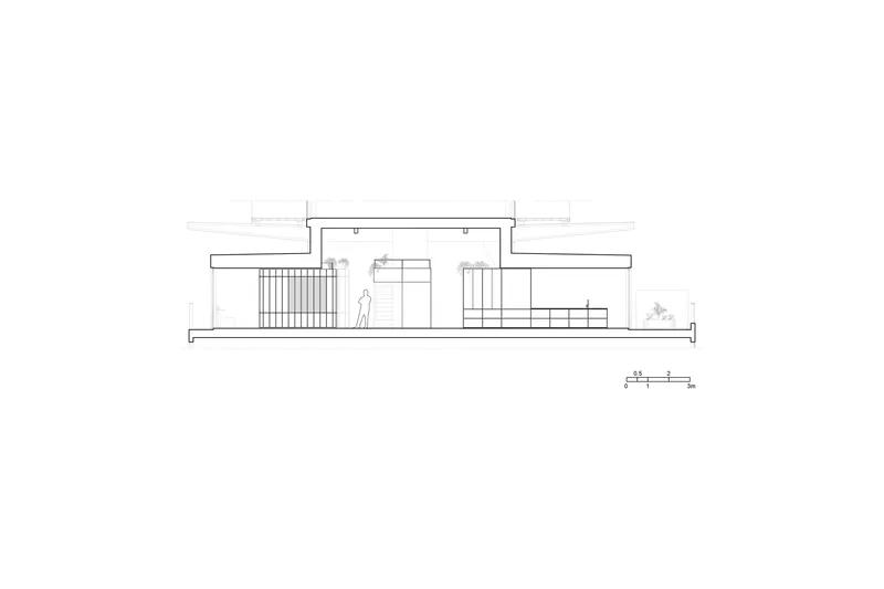 Section drawing revealing interior volumes beneath a cantilevered roof with a figure for scale