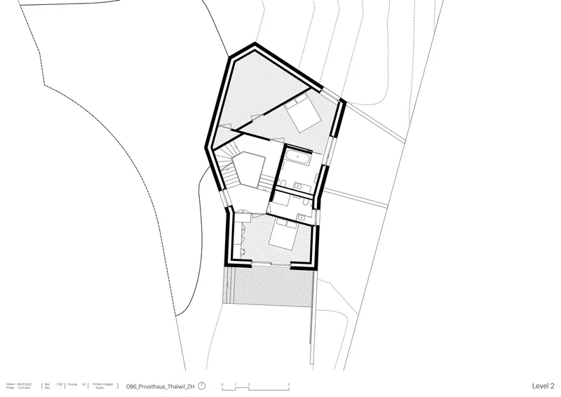Upper level floor plan with central staircase, angled walls, and two bedrooms flanking shared bathroom