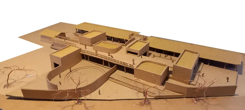 Physical model in cardboard showing clustered volumes around a curved amphitheater with wire trees