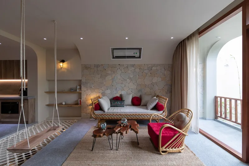 Seating alcove with irregular stone wall and arched openings leading to adjoining spaces