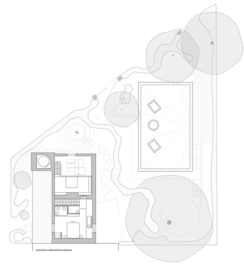 Floor plan drawing showing two rectangular structures with interior partitions surrounded by landscaped terrain with contour lines