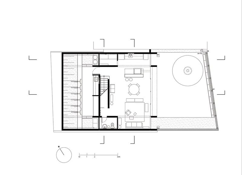 Ground floor plan showing living area with central stair and exterior terrace with circular pool