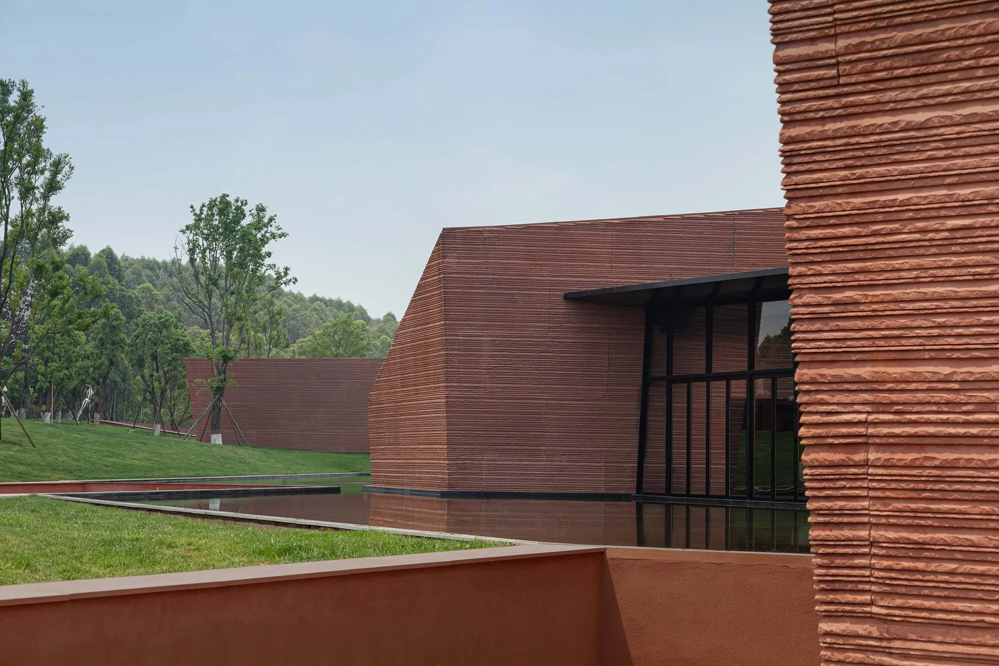 Line+Studio and GAD Scatter Five Stone Volumes Across a Yunnan Hilltop to Form a Cultural Center