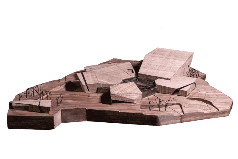 Physical model showing clustered angular volumes with wire trees on a sloped topographic base