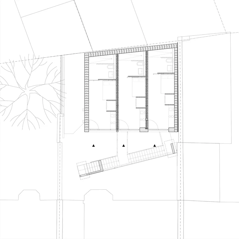 Ground floor plan drawing showing three parallel rooms with a diagonal staircase element and street trees