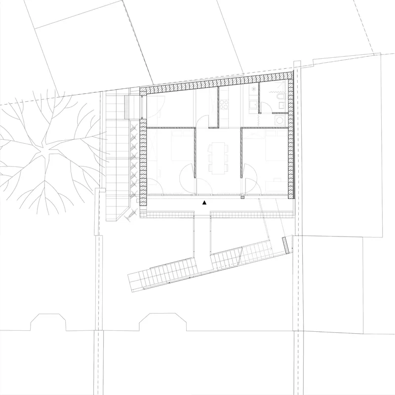 First floor plan drawing showing two interior rooms with a diagonal staircase element and adjacent street trees