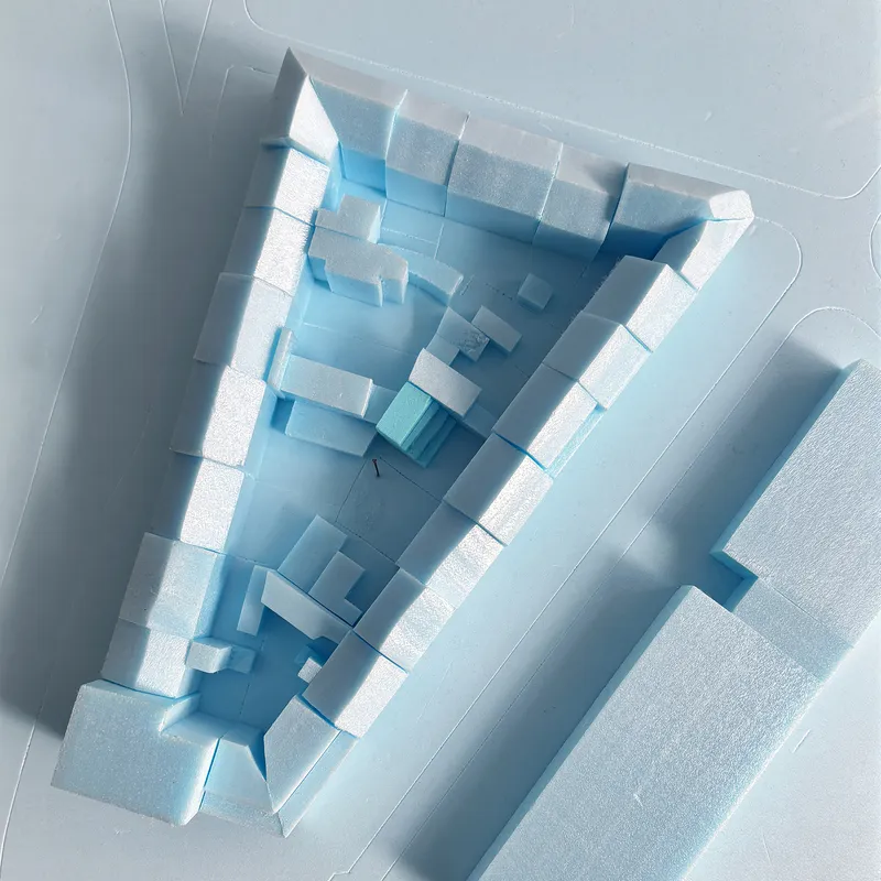 Aerial view of the physical model in white foam showing interior courtyard and surrounding volumes
